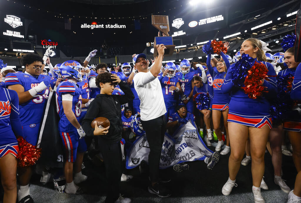 Bishop Gorman head coach Brent Browner lifts the trophy after defeating Arbor View to win the O ...