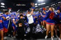 Bishop Gorman head coach Brent Browner lifts the trophy after defeating Arbor View to win the O ...