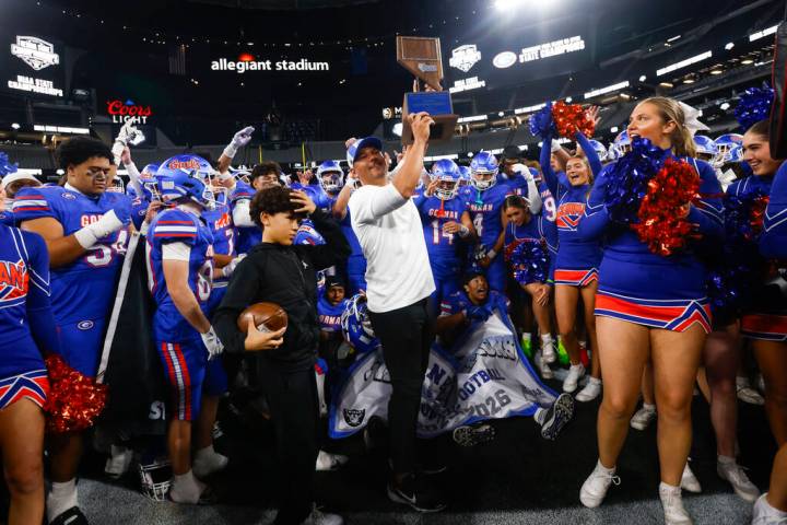Bishop Gorman head coach Brent Browner lifts the trophy after defeating Arbor View to win the O ...