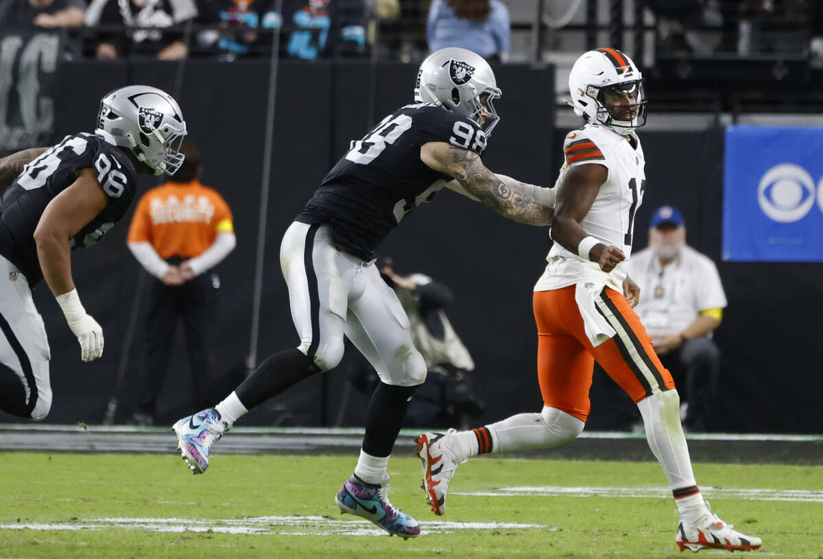 Cleveland Browns quarterback Shedeur Sanders (12) is chased by Raiders defensive end Maxx Crosb ...