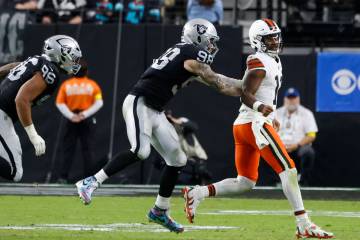 Cleveland Browns quarterback Shedeur Sanders (12) is chased by Raiders defensive end Maxx Crosb ...