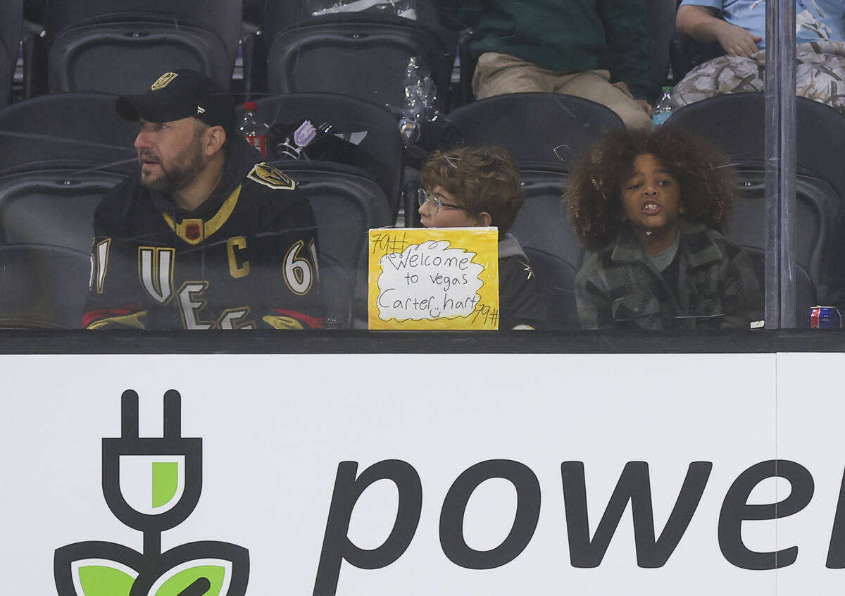 A Silver Knights fan holds up a sign in support of Silver Knights goaltender Carter Hart (79) d ...