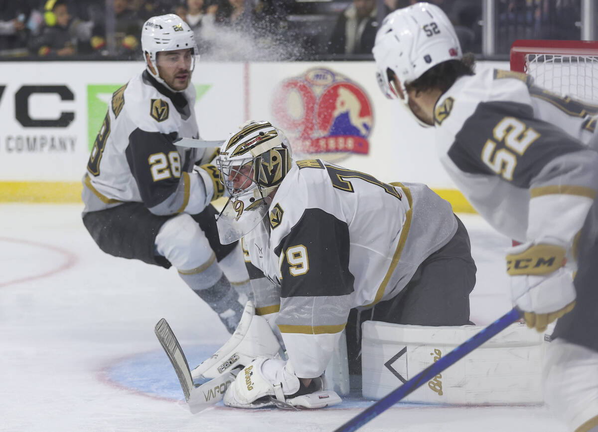 Silver Knights goaltender Carter Hart (79) stops a shot from the Calgary Wranglers during the s ...