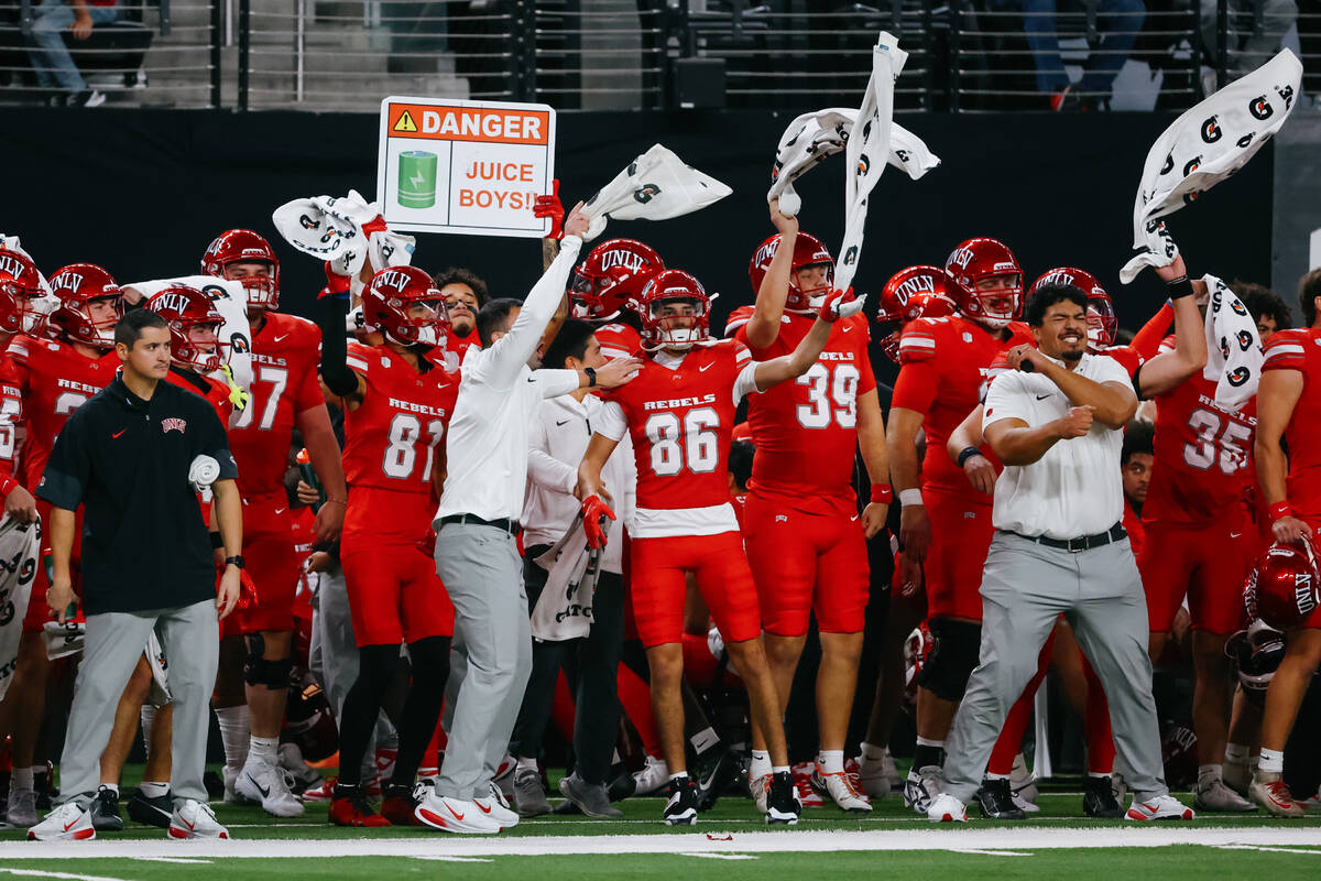 UNLV players swing their towels on the sidelines before a kickoff during the first half of the ...