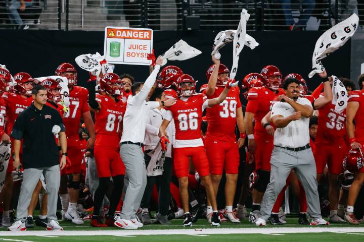 UNLV players swing their towels on the sidelines before a kickoff during the first half of the ...