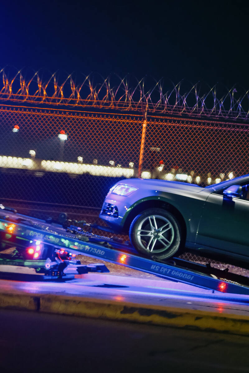 A tow truck tows a vehicle after Metropolitan Police Department officers made an arrest along S ...