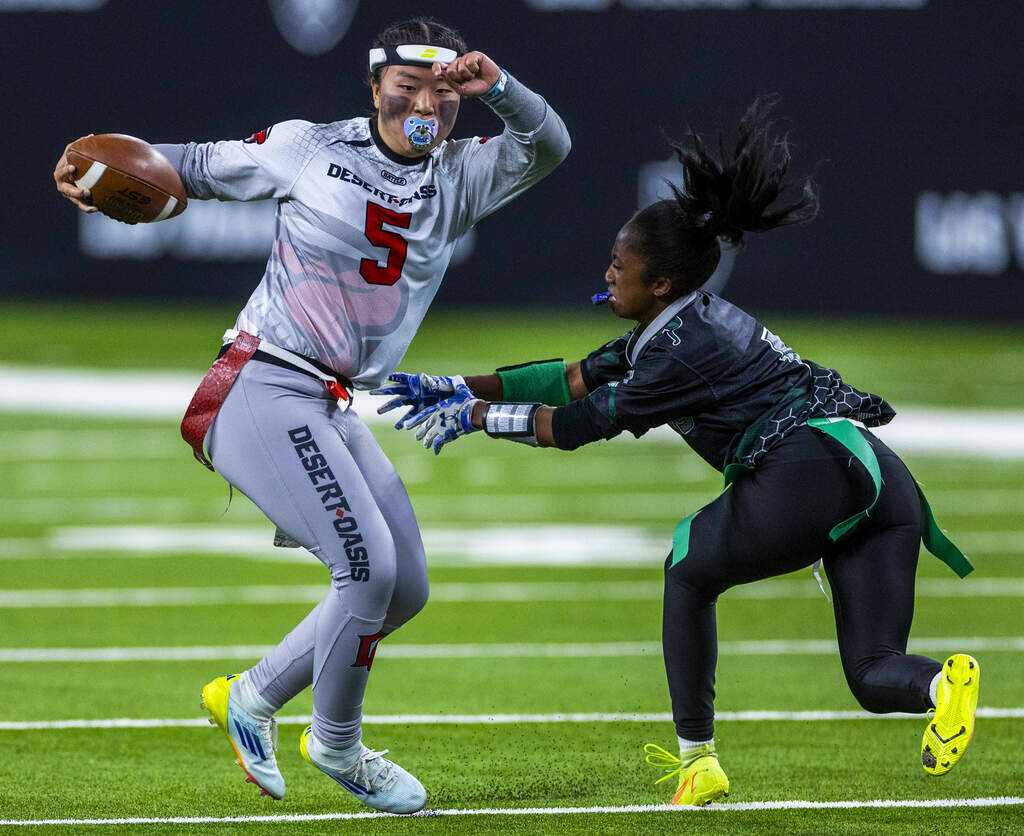 Desert Oasis quarterback Akemi Higa (5) evades a flag pull on a run by Palo Verde linebacker Ma ...