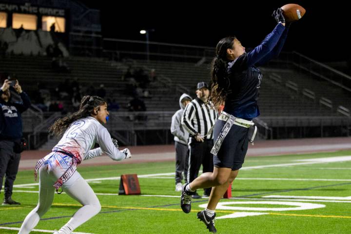 Shadow Ridge junior Jaylani Palmer (12) catches a pass in the end zone during the high school f ...