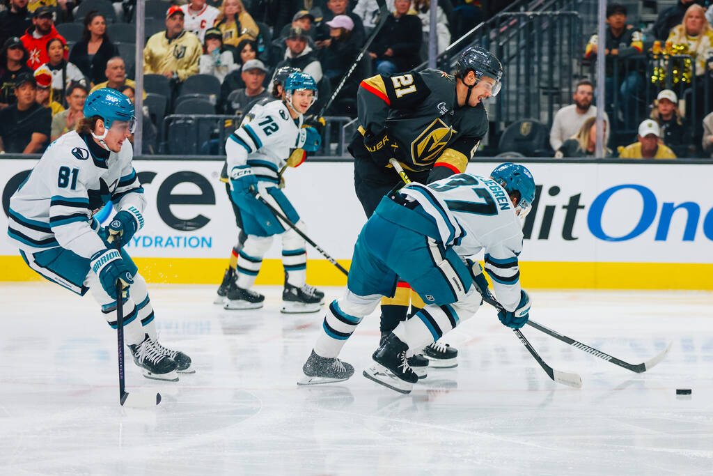 Golden Knights center Brett Howden (21) and San Jose Sharks defenseman Timothy Liljegren (37) r ...