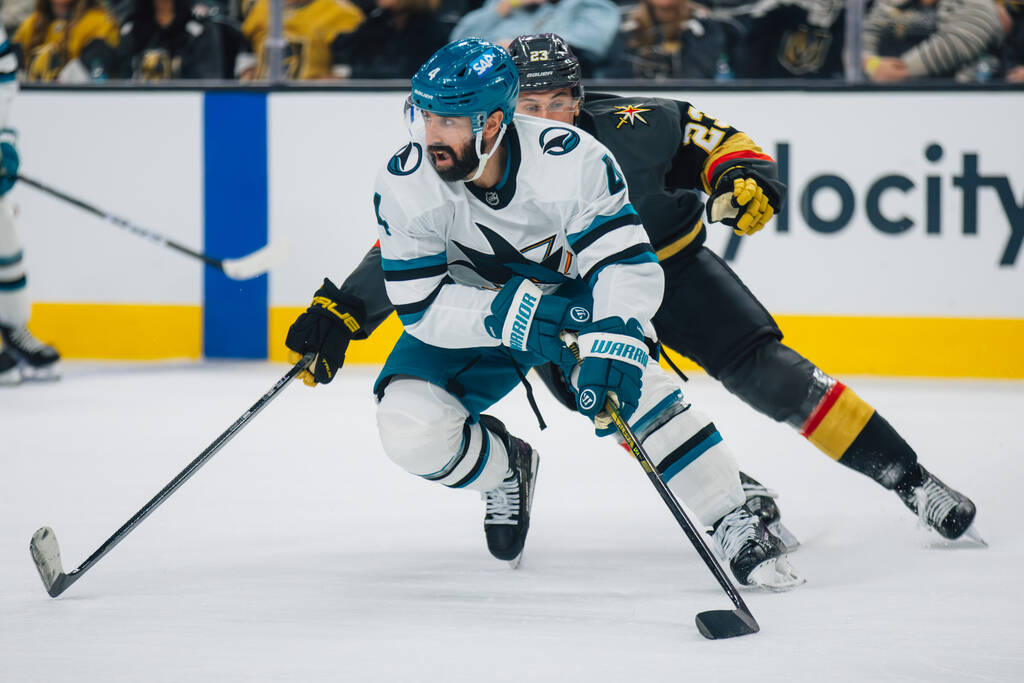 San Jose Sharks defenseman Nick Leddy (4) rounds the ice with the puck as Golden Knights left w ...