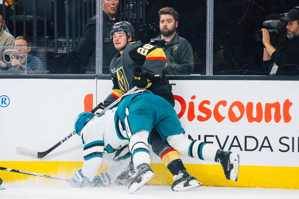 San Jose Sharks defenseman Timothy Liljegren (37) falls over Golden Knights right wing Alexande ...