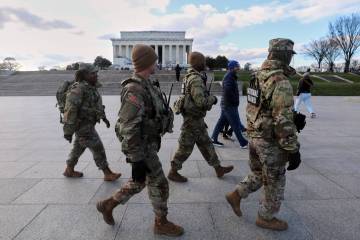 National Guard patrol the National Mall near the Lincoln Memorial, Friday, Nov. 28, 2025, in Wa ...