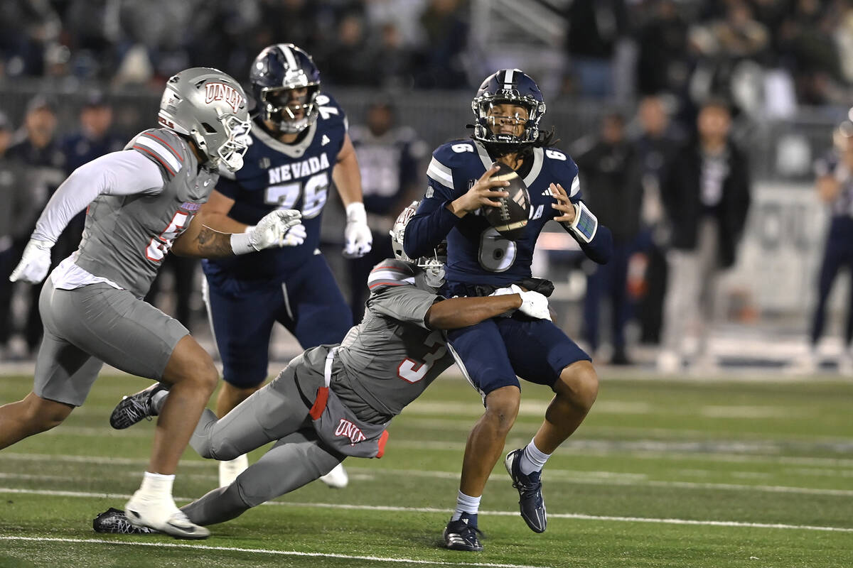 UNLV's Jaheem Joseph sacks Nevada quarterback Carter Jones during the first half of Saturday's ...