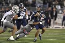 UNLV's Jaheem Joseph sacks Nevada quarterback Carter Jones during the first half of Saturd ...
