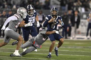 UNLV's Jaheem Joseph sacks Nevada quarterback Carter Jones during the first half of Saturd ...