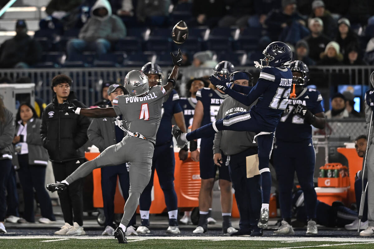 UNLV's Andrew Powdrell breaks up a pass intended for Nevada's Nate Burleson during the second h ...