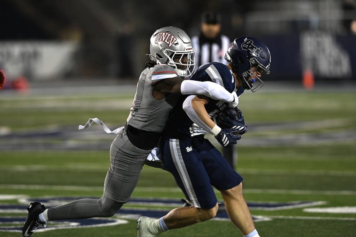 UNLV's Quandarius Keyes tackles Chubba Purdy as he carried the ball for Nevada during the secon ...