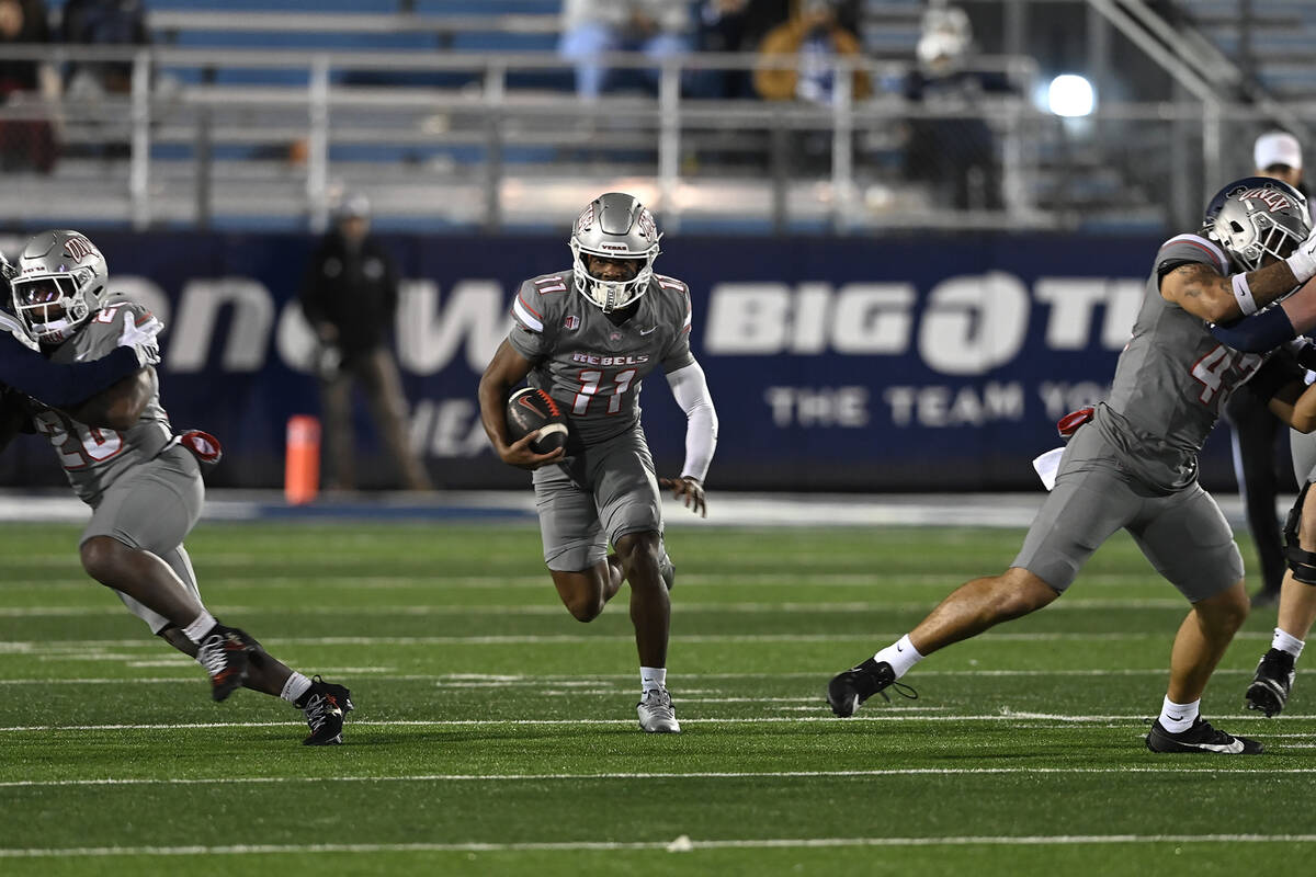 UNLV's Jojo Earle find a big hole to run through against Nevada' during the second half of Satu ...
