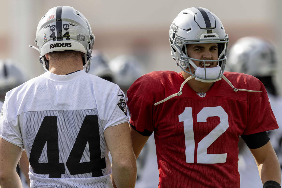 Raiders quarterback Aidan O'Connell (12) greets linebacker Tommy Eichenberg (44) during th ...