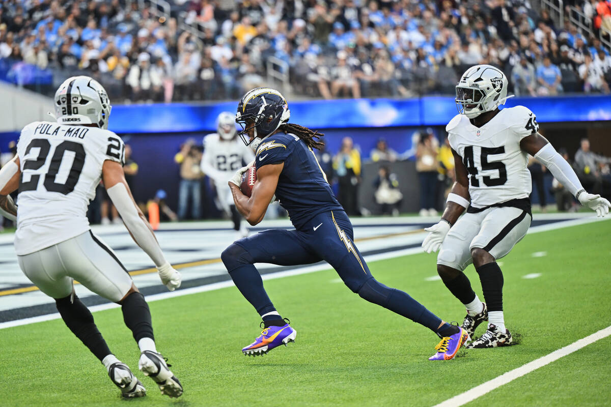 Los Angeles Chargers wide receiver Quentin Johnston, center, runs with the ball for a touchdown ...