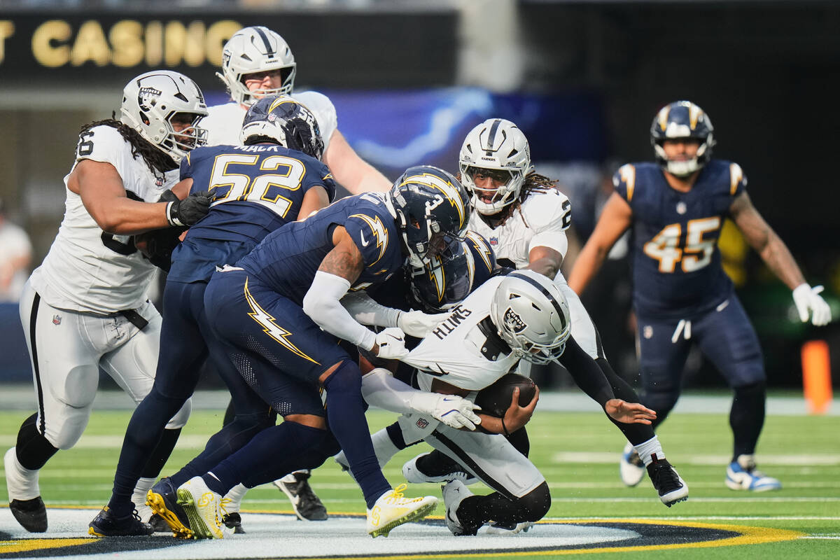 Los Angeles Chargers safety Derwin James Jr. (3) sacks Las Vegas Raiders quarterback Geno Smith ...