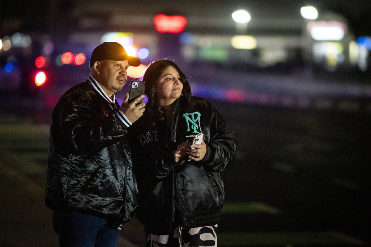 Bystanders watch at the scene of a mass shooting Saturday, Nov. 29, 2025, in Stockton, Calif. ( ...