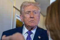 President Donald Trump speaks with reporters while in flight on Air Force One from his Mar-a-La ...