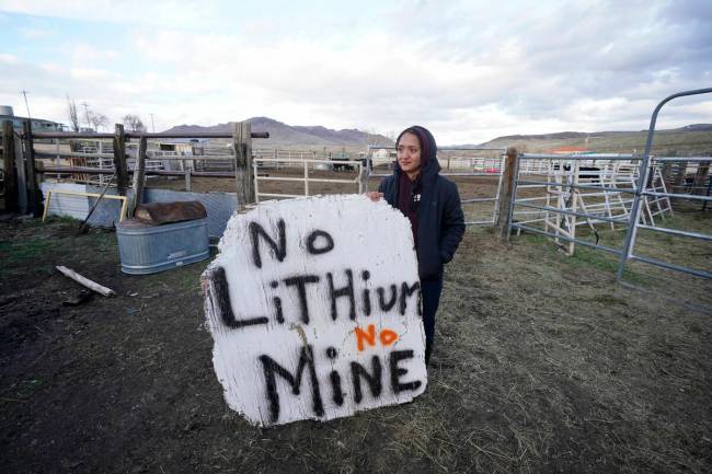 Daranda Hinkey, a Fort McDermitt Paiute and Shoshone Tribe member, holds a large hand-painted s ...