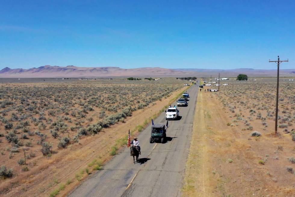 Tribal member Kess Hinkey leads the procession during a parade celebrating the 136th birthday o ...