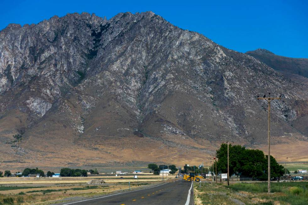 A farm vehicle crosses the Kings River Valley Road in the valley below the Thacker Pass mine pr ...