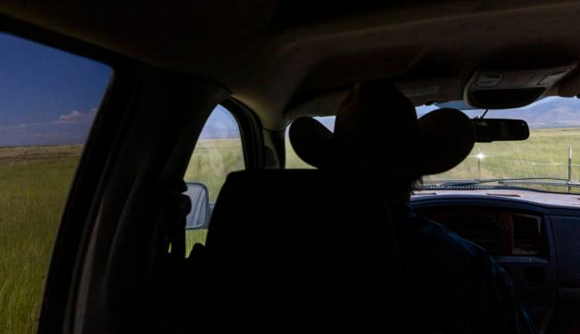 Rancher Ed Bartell drives his range land inspecting water holes to ensure the water table has n ...