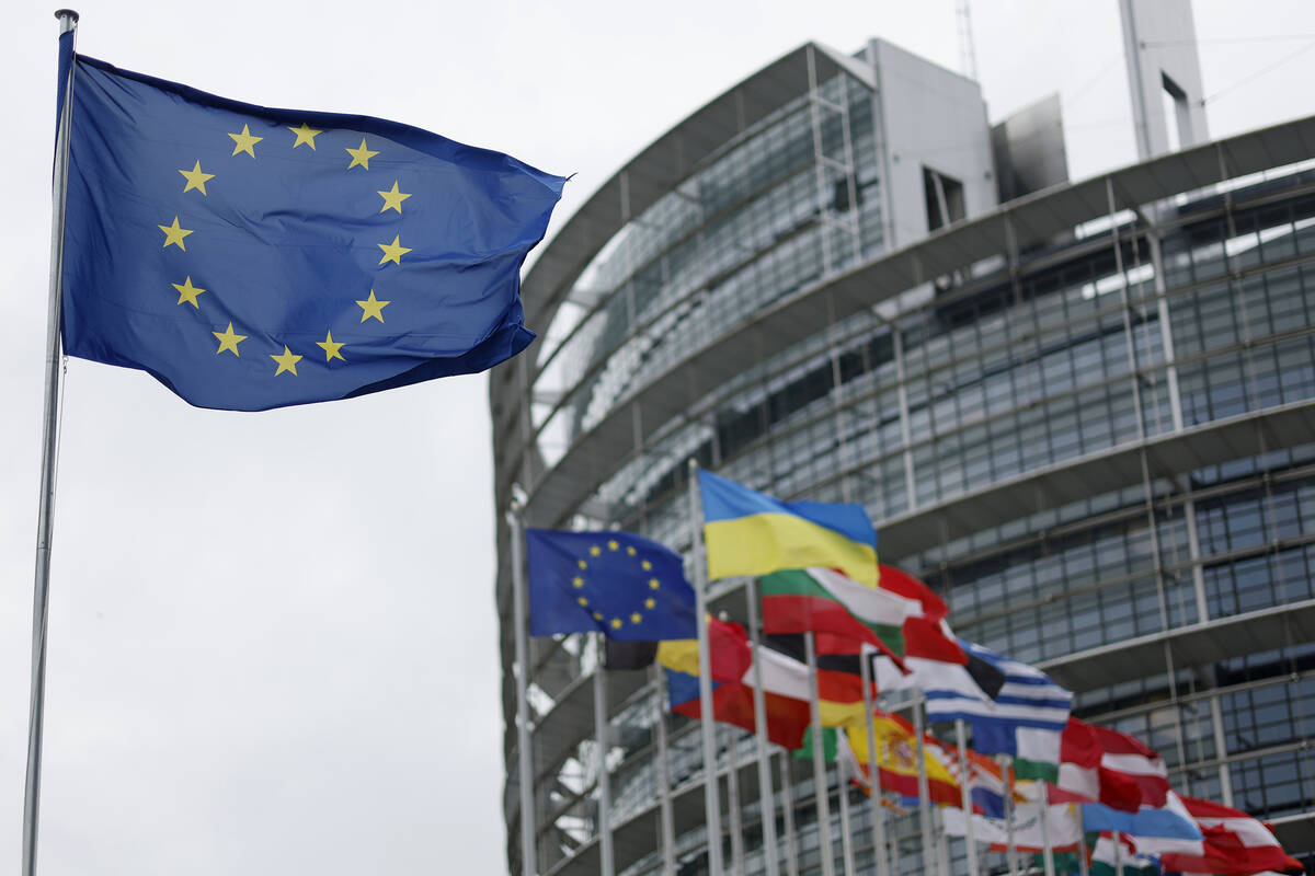 The European flag, left, flies at the European Parliament in Strasbourg. (AP Photo/Jean-Francoi ...