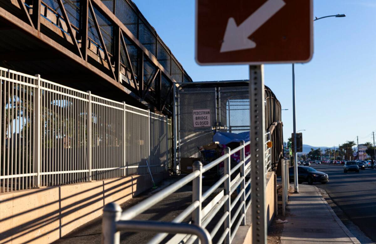 A closed overhead pedestrian bridge is seen near a memorial for Jon Silk, a pedestrian who was ...
