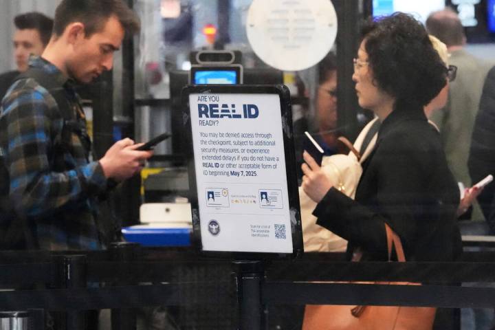 A Real ID sign is displayed as travelers wait to go through security check point at O'Hare Inte ...