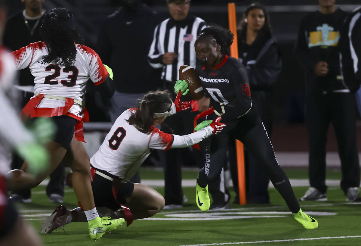 Desert Oasis' Makiah Ball (0) runs the ball under pressure from Las Vegas’ Madalynn ...