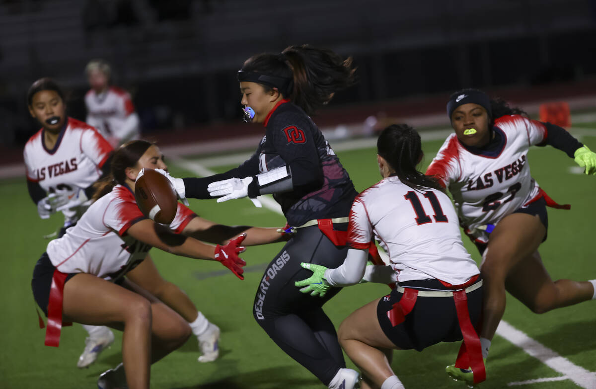 Desert Oasis' Akiko Higa (29) runs the ball as Las Vegas players, including Karsyn Brinker ...