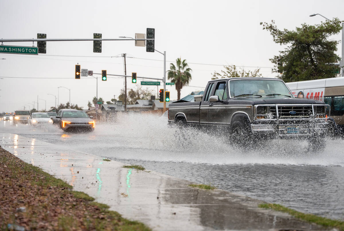 Water levels rise at the intersection of North Jones Blvd. and W. Washington Ave. Tuesday after ...