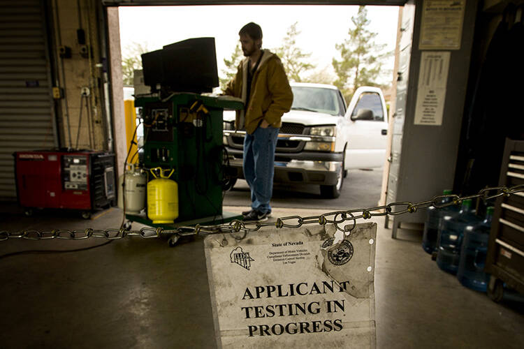 Ryan Bettencourt conducts an smog emissions test on Jan. 28, 2015, at Nevada Department of Moto ...