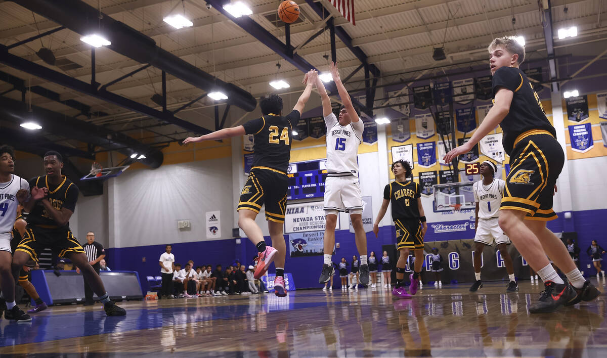 Desert Pines wing Tyler Merto (15) shoots over Clark forward Andrew Yeung (24) during the first ...