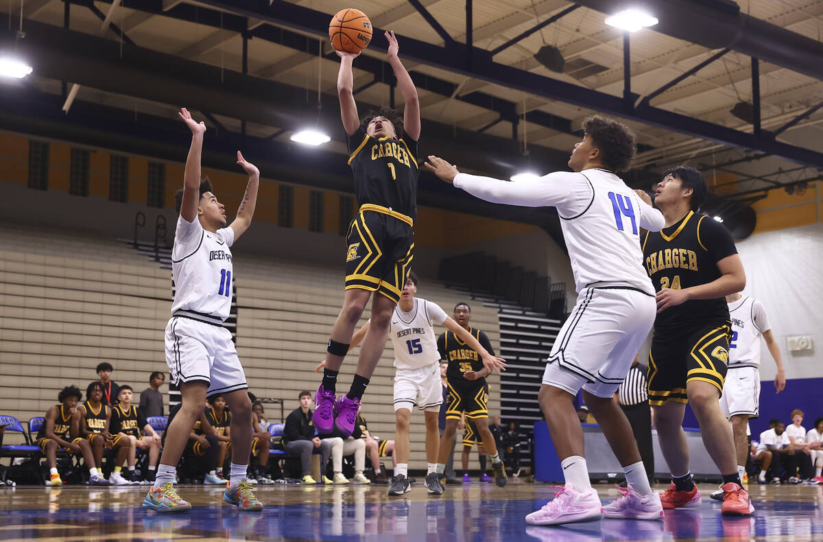 Clark point guard/shooting guard CJ Edwards (0) lays up the ball against Desert Pines during th ...