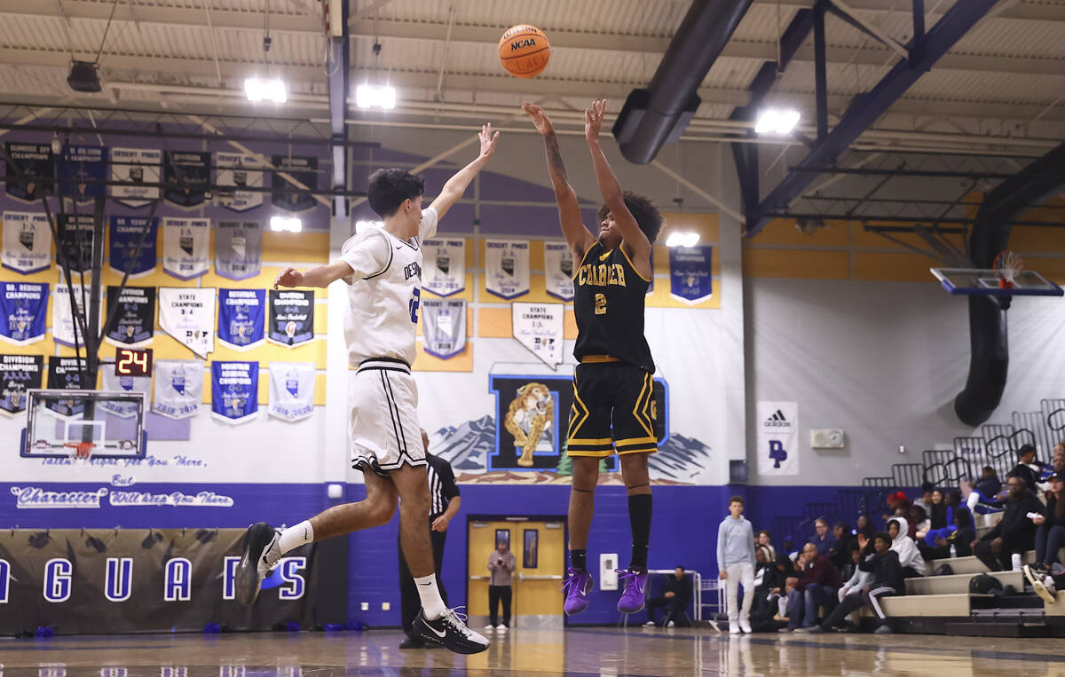 Clark point guard/shooting guard Sir Montgomery (2) shoots over Desert Pines guard Aaron McMorr ...