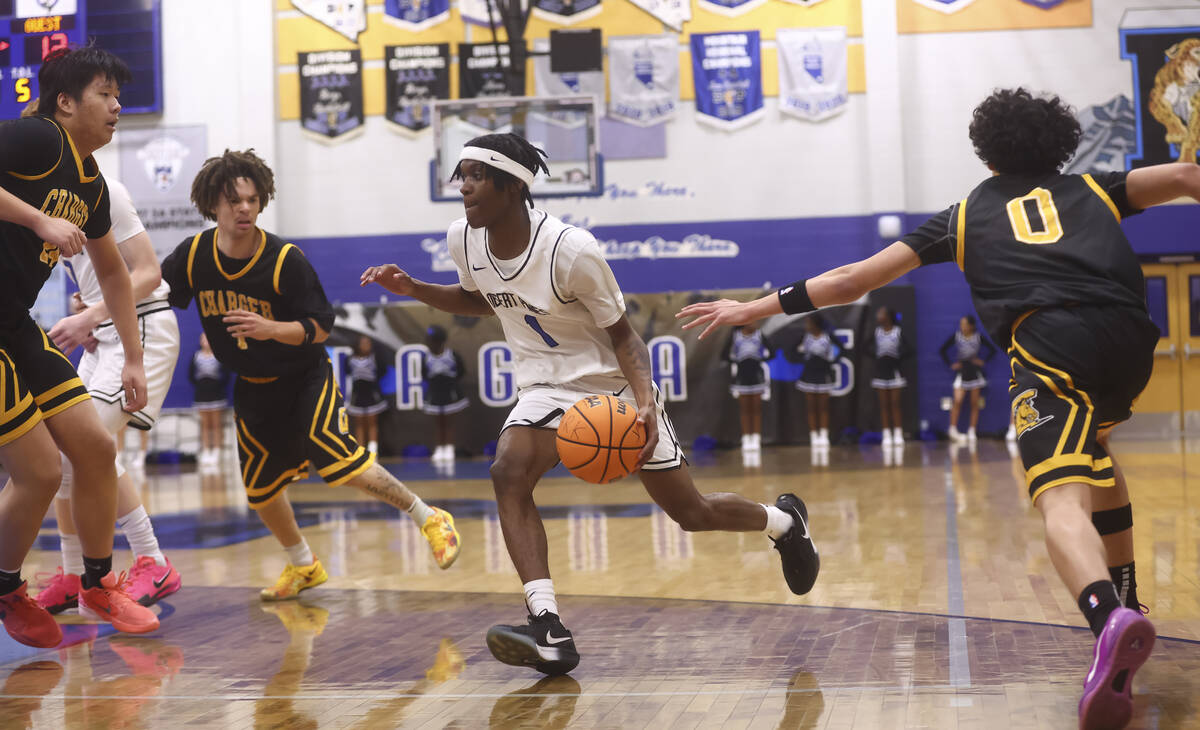 Desert Pines guard Lavelle Lovelace (1) drives to the basket against Clark during the first hal ...