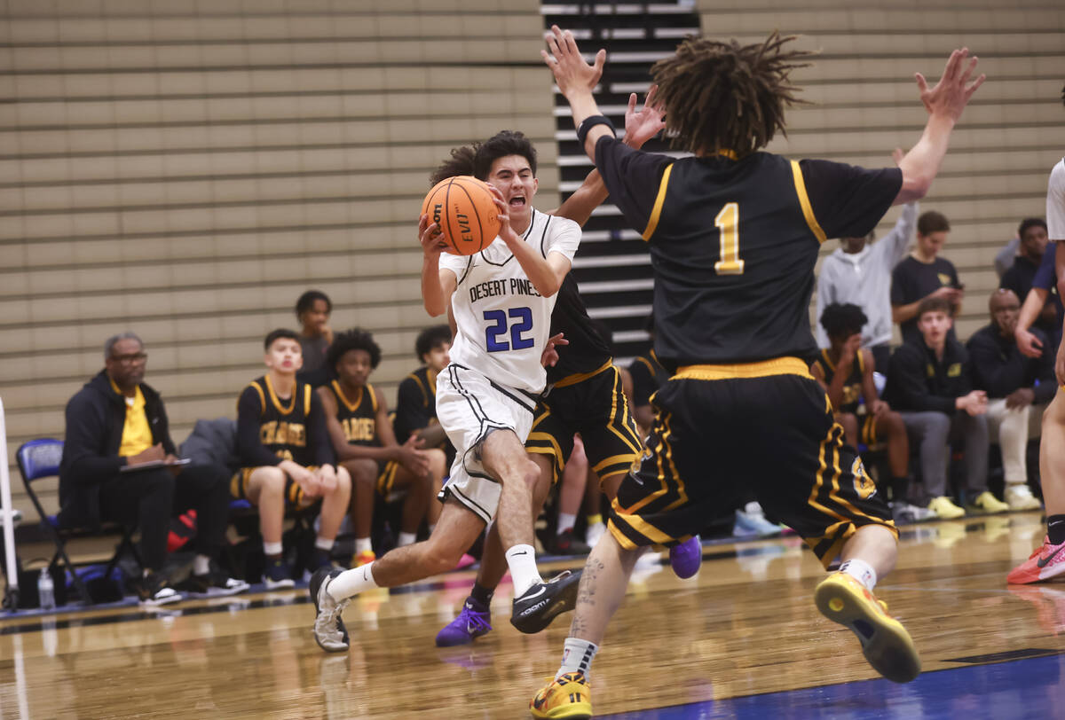 Desert Pines guard Aaron McMorran (22) drives to the basket against Clark during the first half ...