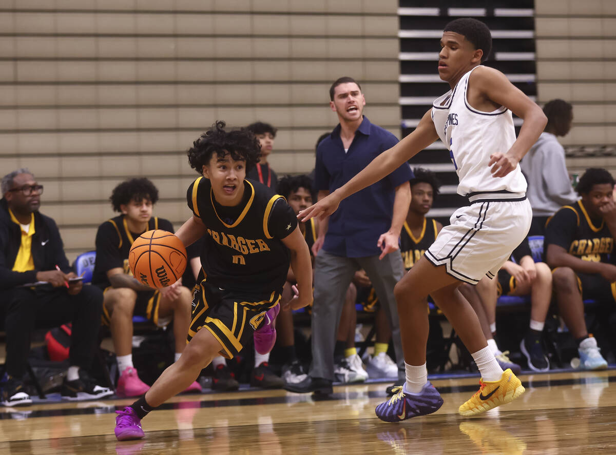 Clark point guard/shooting guard CJ Edwards (0) drives to the basket against Desert Pines guard ...