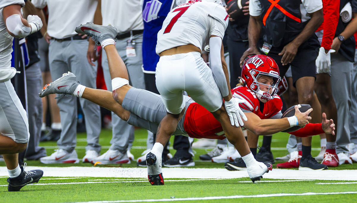 UNLV quarterback Anthony Colandrea (10) dives for a late first down as New Mexico Lobos safety ...