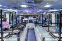 A Transportation Security Administration employee demonstrates a self-service passenger screeni ...