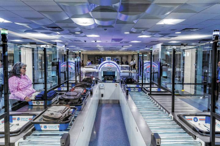 A Transportation Security Administration employee demonstrates a self-service passenger screeni ...