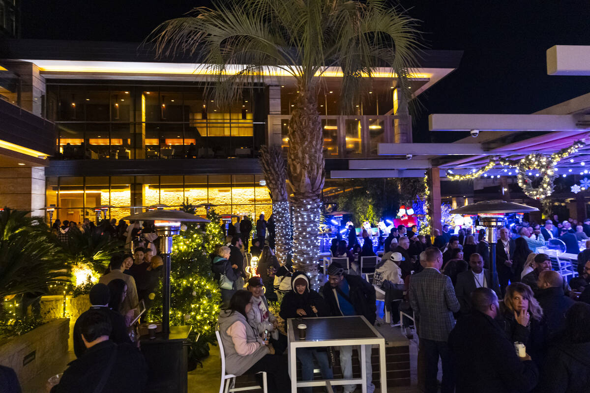 Attendees mingle by the pool area during the grand opening celebration for the M Resort's ...