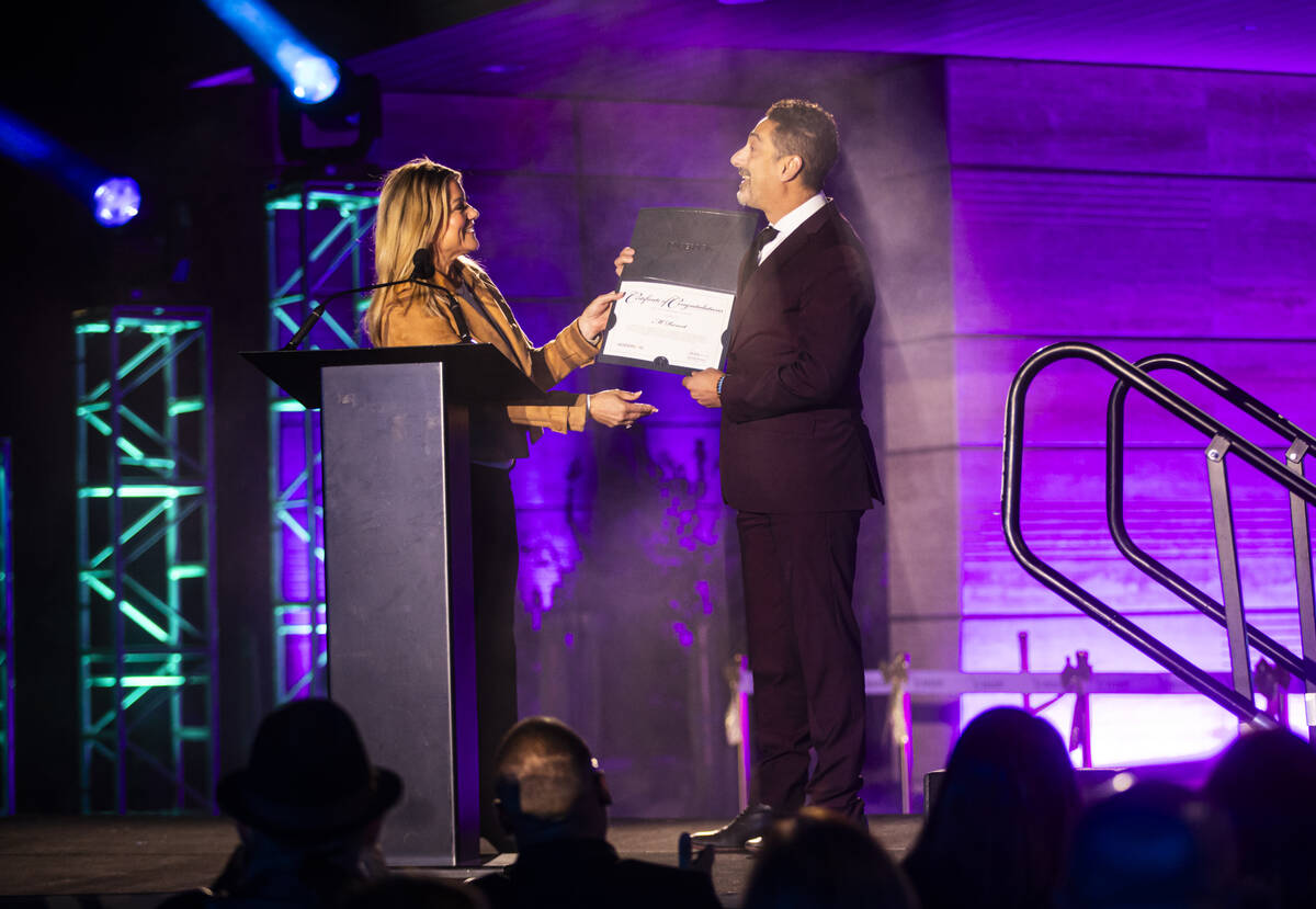 Henderson Mayor Michelle Romero hands a certificate of recognition to Hussain Mahrous, vice pre ...