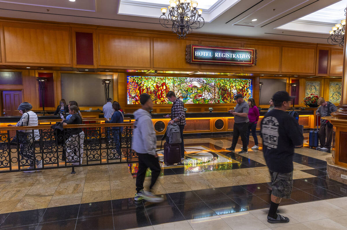 People wait in line to be served at hotel registration within the South Point on Friday, Nov. 1 ...